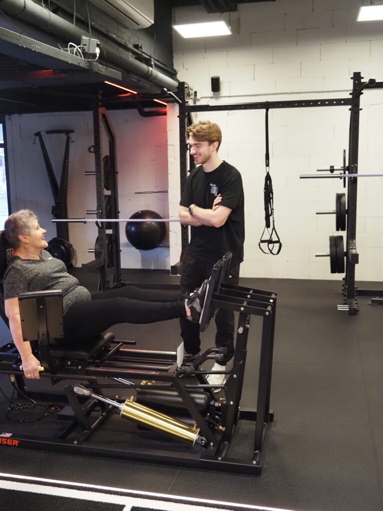 Fysiotherapeut begeleidt een patiënt bij krachttraining voor artrose