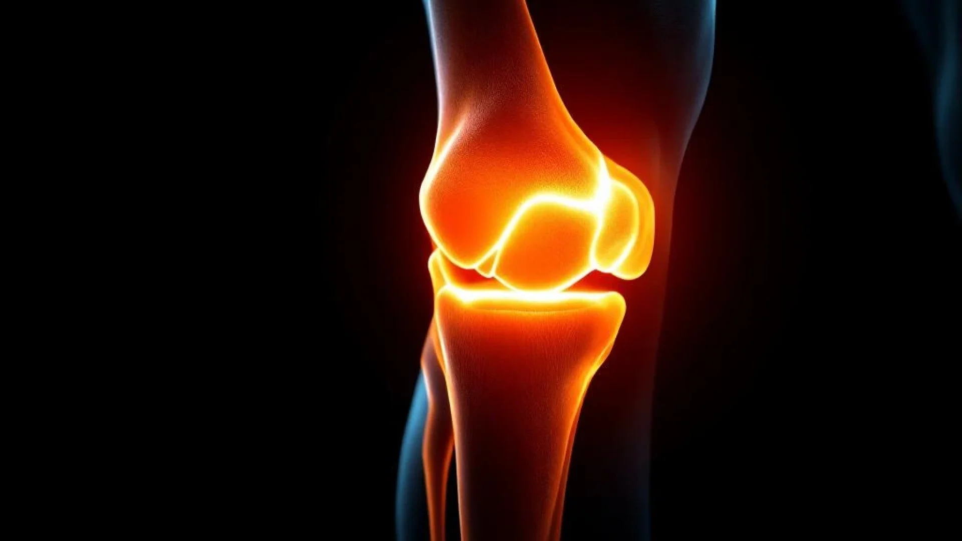 Menselijke knie in profiel met oranje medische belichting tegen zwarte achtergrond voor fysiotherapie artikel